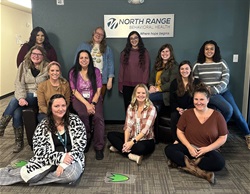 North Range Behavior Health team, a group of twelve women, smiling at the camera