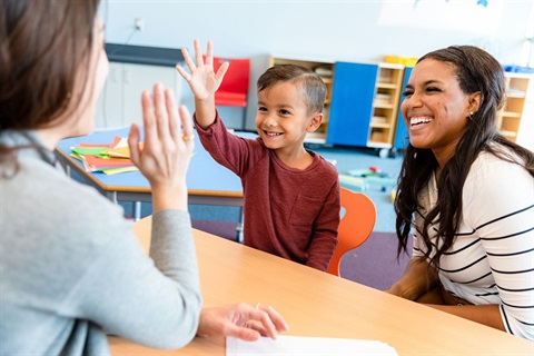 Teacher giving a high five to a child