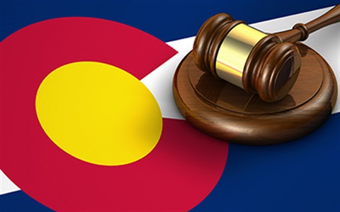 Picture of a gavel on a background of the colorado flag.
