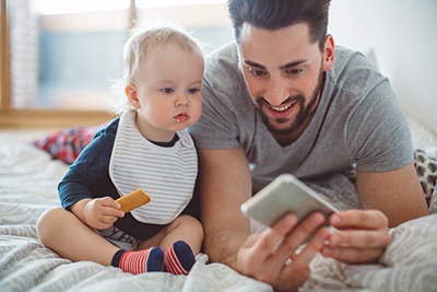 Father and infant looking at phone